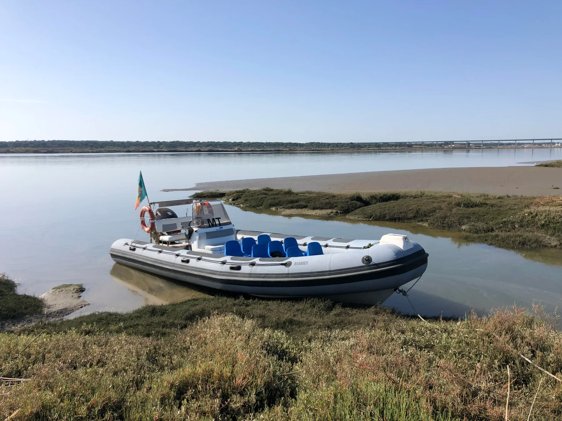 Subida do Sado boat on the river with blue passenger seats