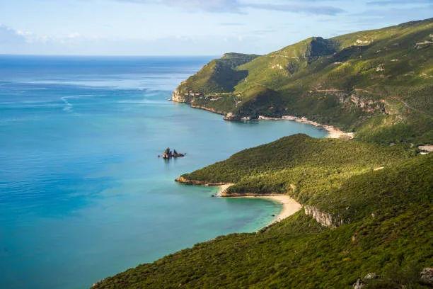 The green slopes and blue water of the Arrábida coast