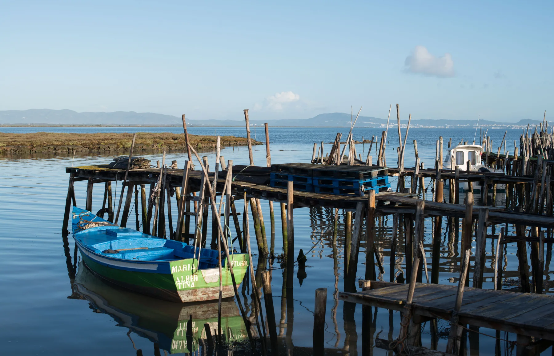 Wooden walkways and fishing boats at Carrasqueira harbour