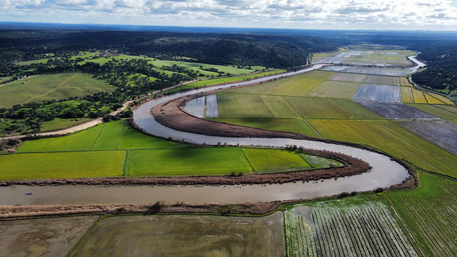 The winding Sado River through green fields and wetlands